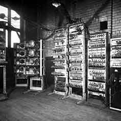 In black and white, the right-hand view of a room full of data cabinets.