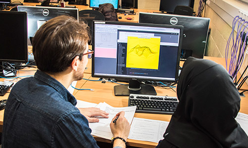 Two women looking at a computer monitor