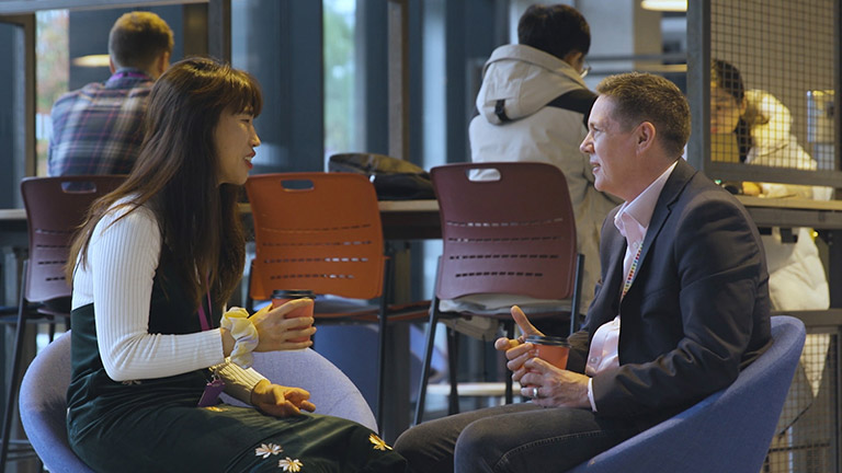 PhD student discussing their work with a supervisor