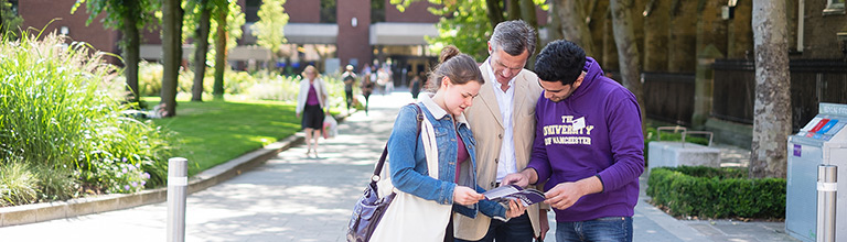 Prospective student, parent and volunteer looking at map on open day
